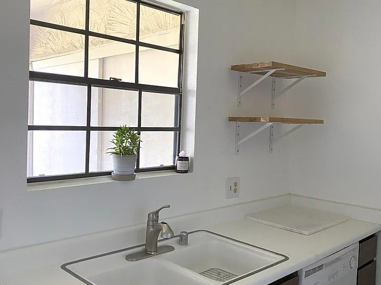 Cute kitchen with ample storage, dishwasher and fridge