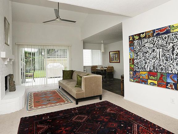 Wide open foyer is open to one of two living areas down, providing access to the outside and kitchen area.