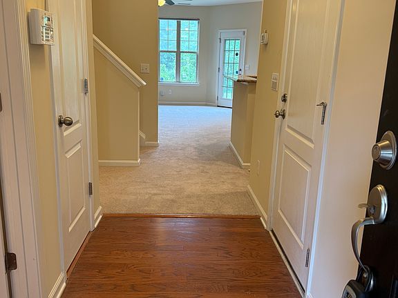 Beautiful Entry wood floors into brand new carpeting.