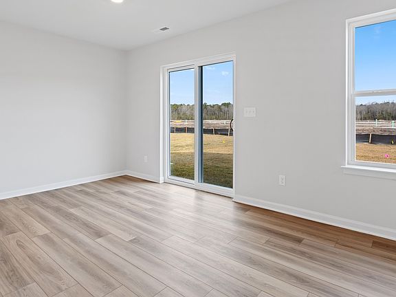 Dining area with sliding glass door to back yard in a DRB Homes Edgewood plan at The Village of Coll