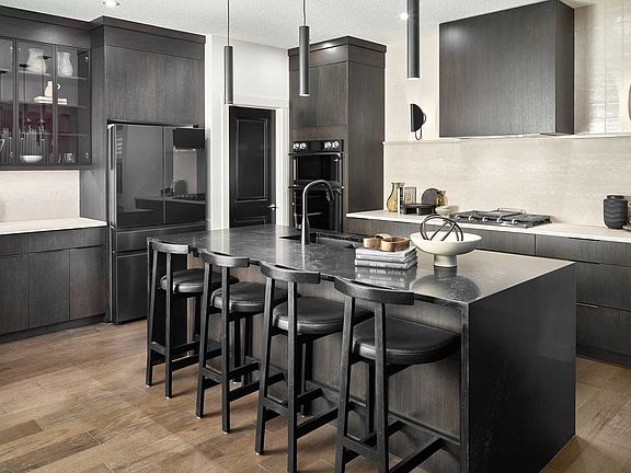 Where dark countertops seamlessly blend with modern design, creating an ambiance that s as stylish a