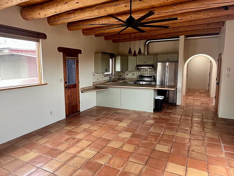 Classic New Mexico charm with wood vigas and salltillo tiles in the main residence.