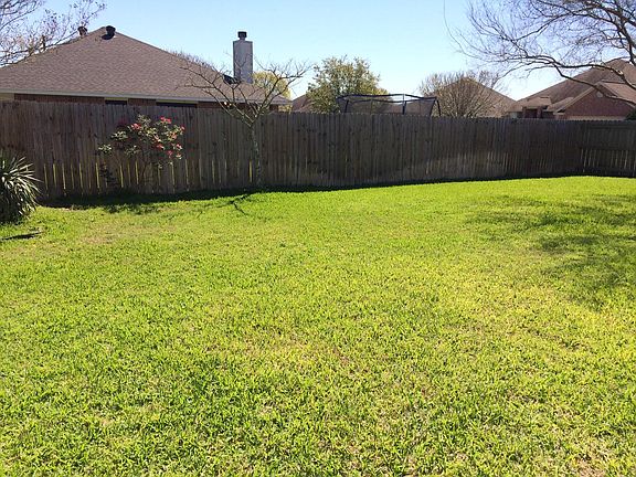 Large corner lot backyard with paver patio and covered patio