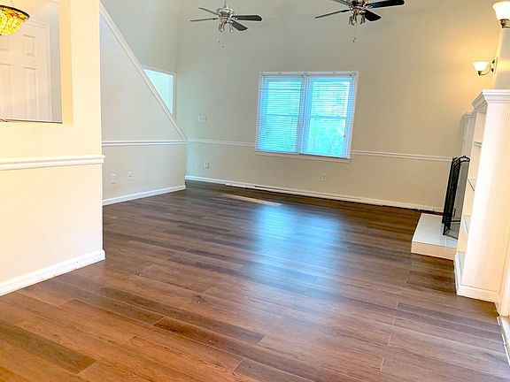 Large open concept great room with cathedral ceilings and new LVT