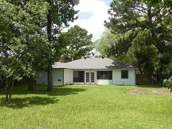 Mature shade trees. Patio by the French doors.