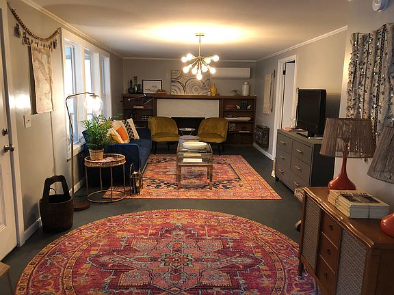 View from dining room into living room. Door to screened in porch is on the left.