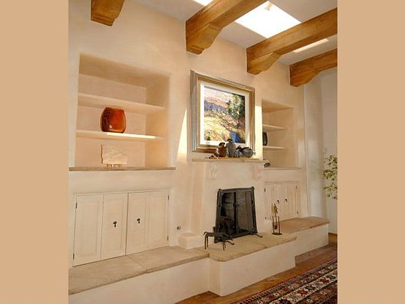 There are beams and Corbels above along with skylights and media cabinets and built-in shelves flank
