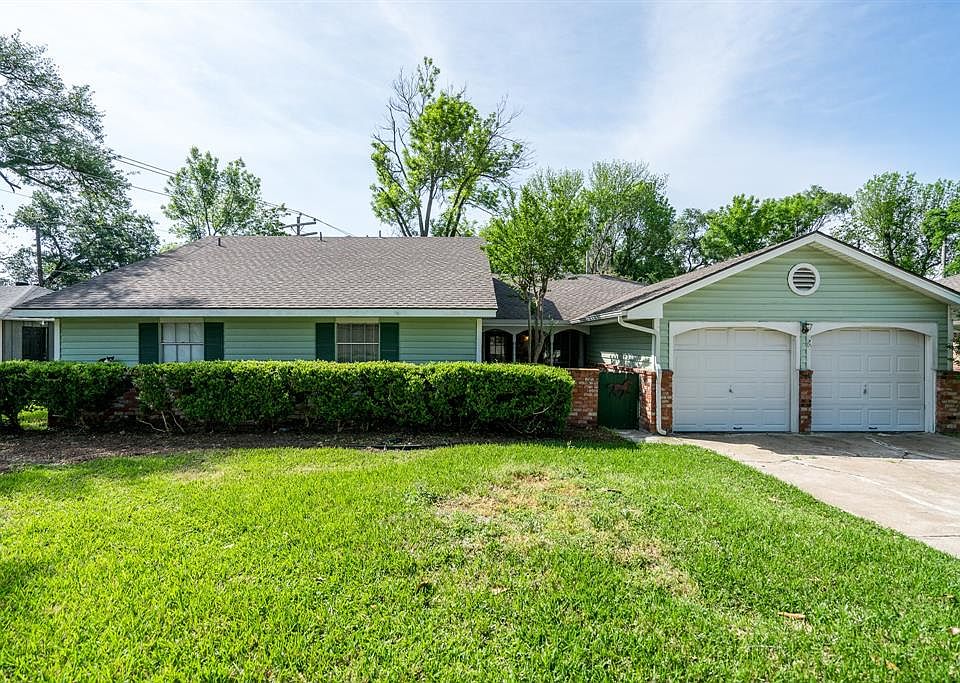 Welcome to 11119 Hazelhurst Drive in Sherwood Oaks. The cute exterior is wood and brick featuring a gated entrance into the courtyard.