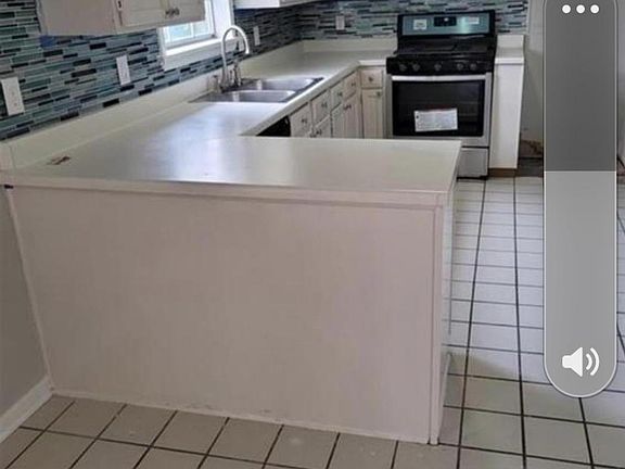 Kitchen with new oven, microwave. Refrigerator now in unit and washing and dryer downstairs in basement