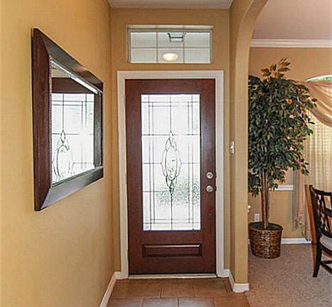 Enter the home and find beautiful tile floors and an arched entry to the dining room.