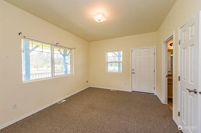 first floor bedroom with attached full bathroom and exterior door