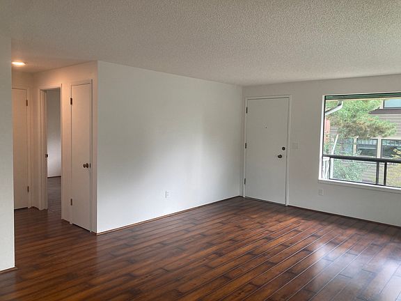 One of the various photos depicting large living/dinning room.