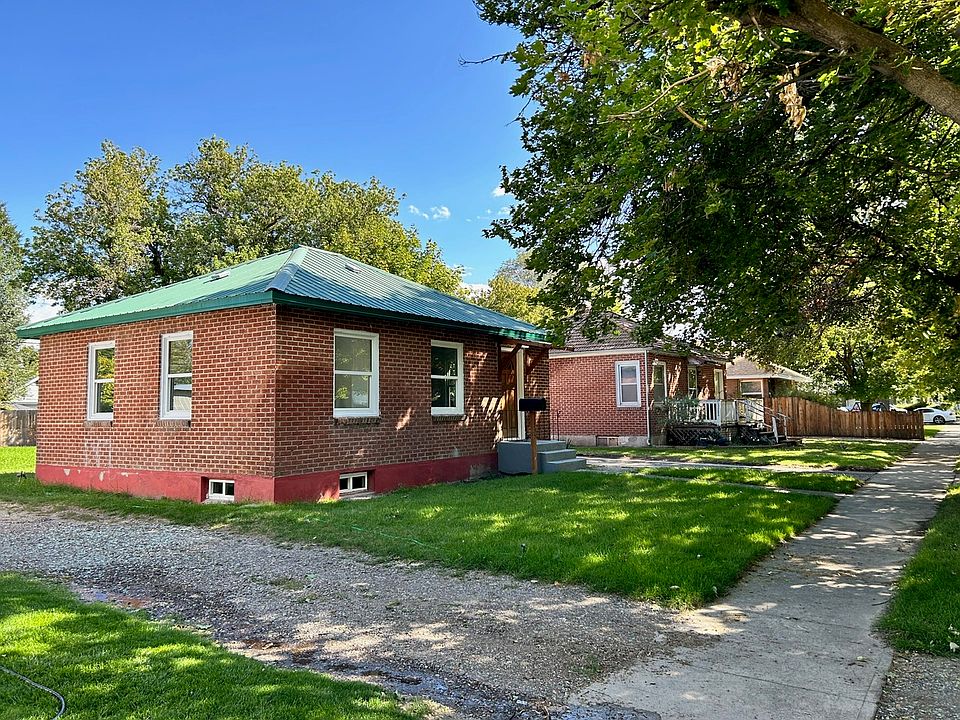 Quiet setting with tree lined street and sidewalks.