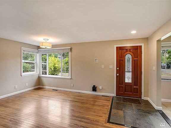 As you enter the home you're greeted by the large living room. Made light and bright by the corner windows, this home has had its windows upgraded to vinyl double panes.