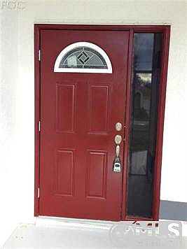 Even the front door has unique details.  Check out the caning on the arched window in the door.  The red color really pops with the predominant silver and gray color scheme ~