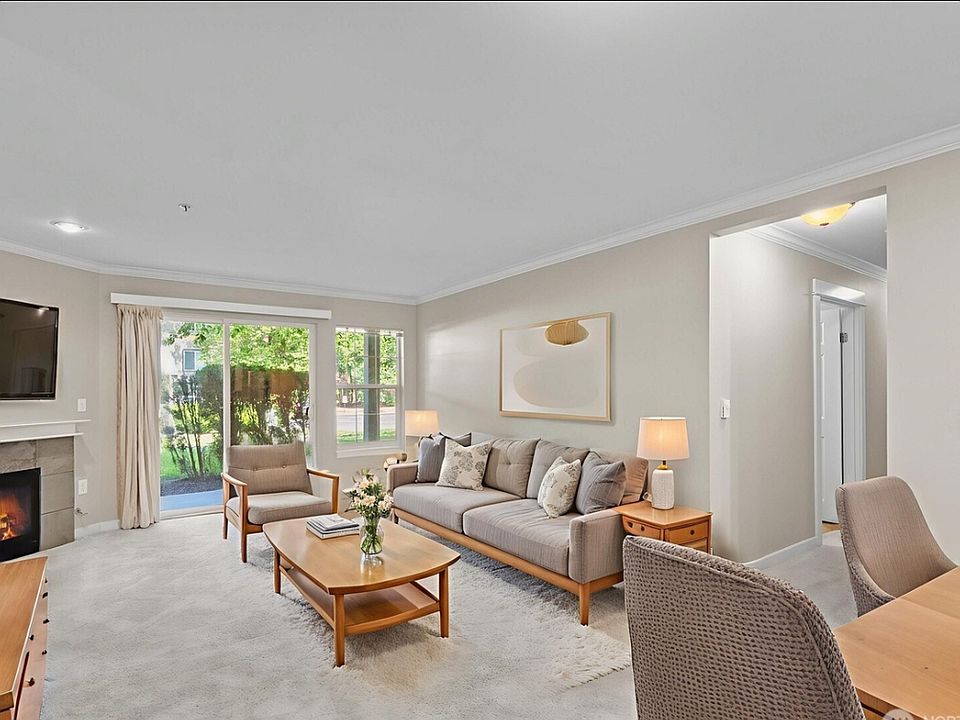 Open concept living room with gas fire place and walk out patio