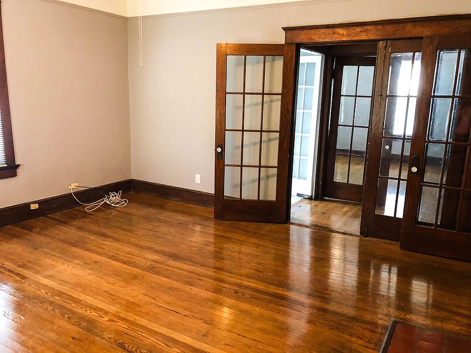 French doors add lots of light and 100 year old flooring has been lovingly maintained