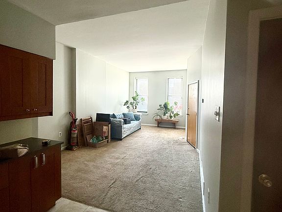 view of living room from kitchen. Living room is a front of house