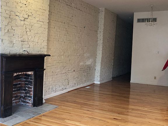 living room/dining area with decorative fireplace/mantle. (NOT wood burning)