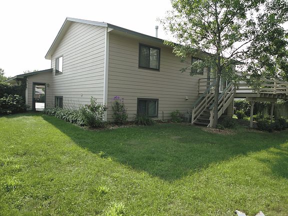 Private, fenced in backyard with a fire pit