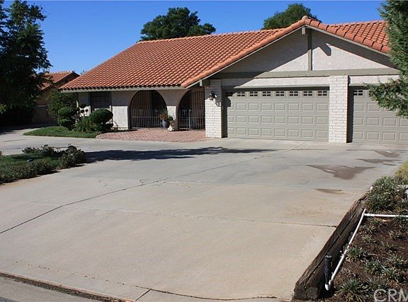 Curved driveway with attached 3 car garage.
