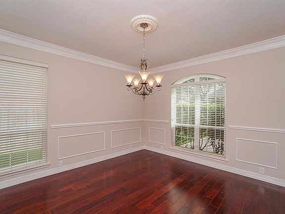 Elegant Formal dining room with wall paneling and chair railing
