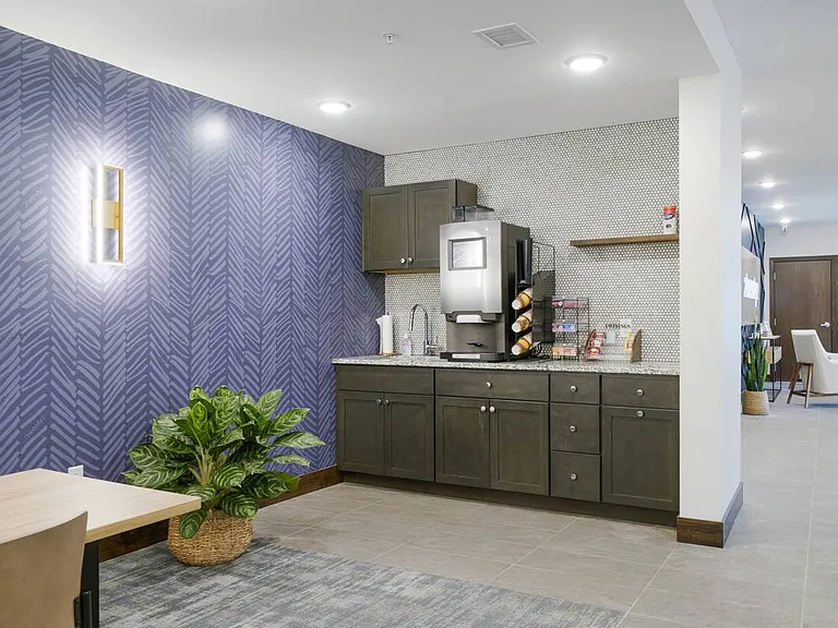 A dedicated coffee station makes it easy to grab a fresh cup and settle into a relaxed conversation or a quiet break.
