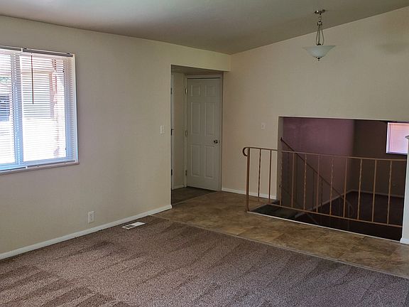 Additional view of living room and entryway from dining area