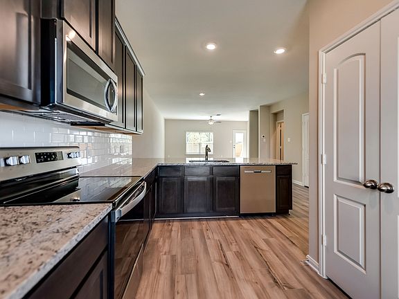 The kitchen comes with a full suite of stainless steel appliances.