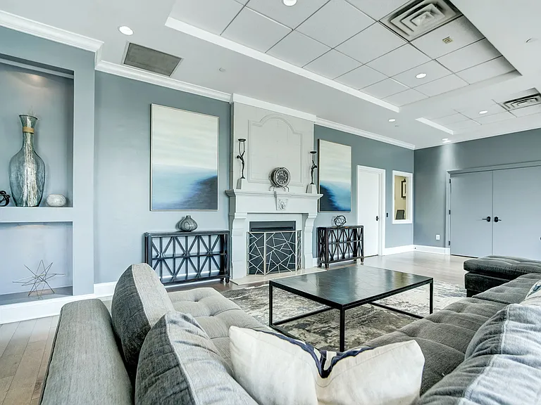 Expansive Resident Clubhouse with Plush Seating Areas, Cozy Fireplace, Balcony Area, and Bar