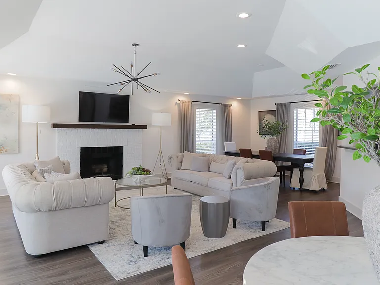 Our Montgomery apartments include a cozy resident lounge with fireplace and wall-mounted television, professionally operated by Highlands Vista Group.