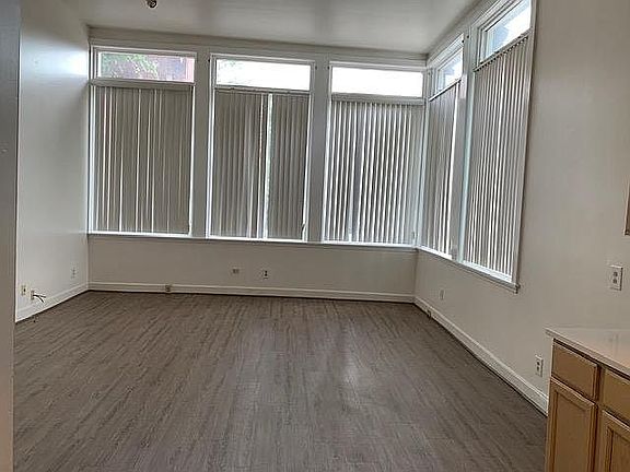 High ceiling and windows in spacious living room