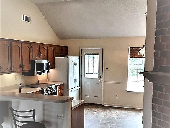 Well appointed kitchen with lots of storage, high ceilings and access to spacious back yard.