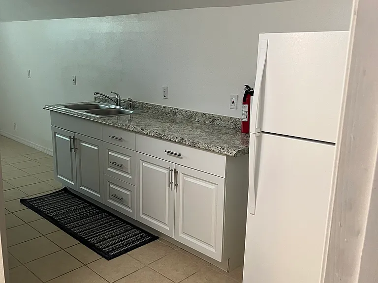 Another view of the kitchen with the refrigerator