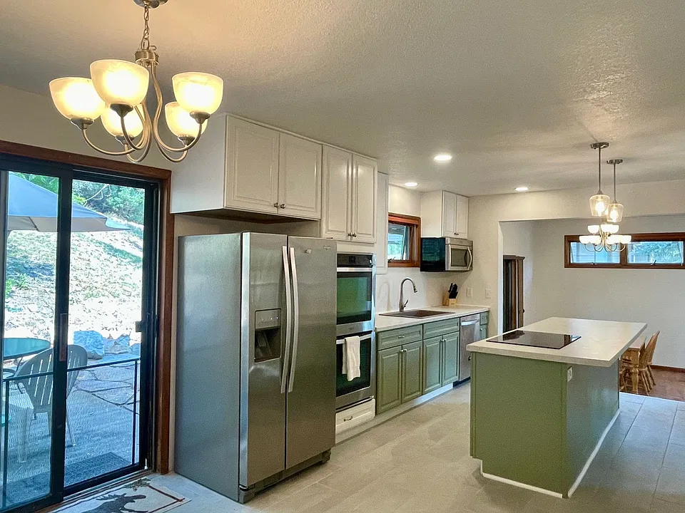 Renovated kitchen with breakfast nook and outdoor patio with grill