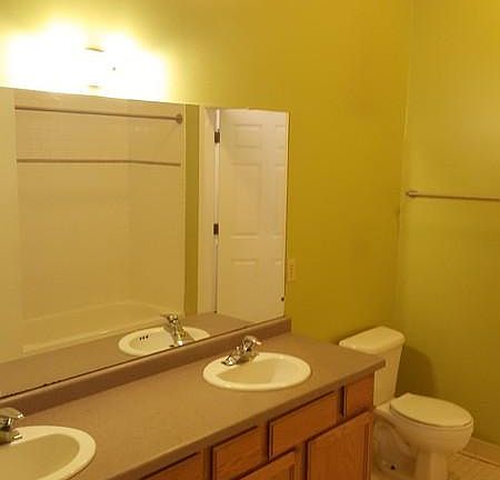 Huge front bathroom with double vanity, tub, closet, and lau