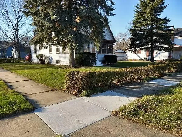 From corner (but hedge row along the sidewalk is removed)