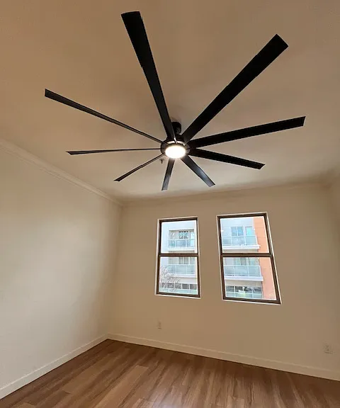 Big Ass Fan. in the living area with two large windows looking over Lewis St to the right is the door to the private balcony