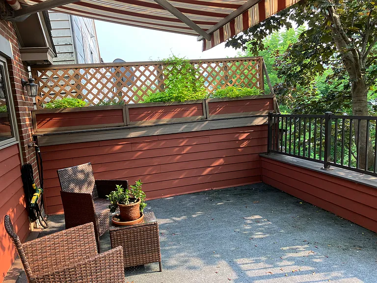 Deck outside kitchen, awning, on river