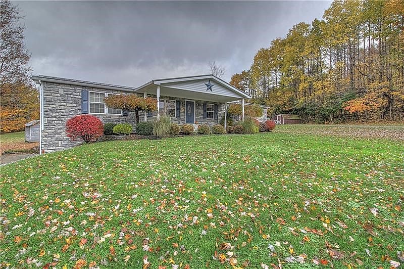 Beautiful stone front and sides boasting covered front porch and expansive front lawn.