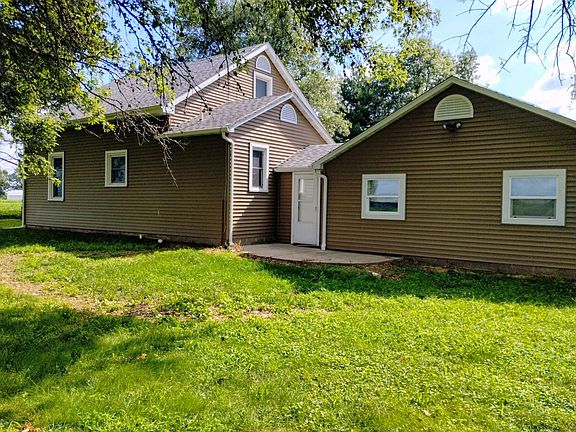 REAR OF HOUSE HAS A SMALL PATIO AREA.