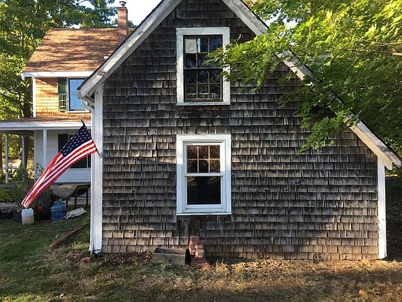Attached woodshed with two-level storage.