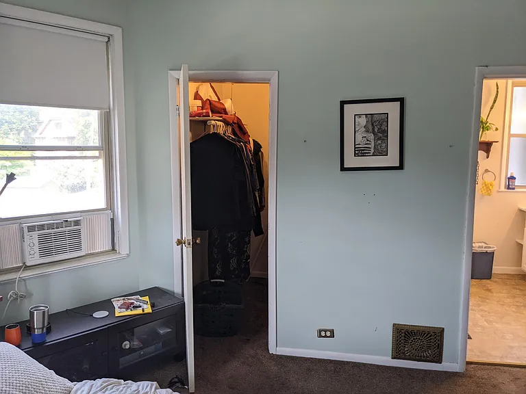Primary bedroom with walk in closet and door to bathroom