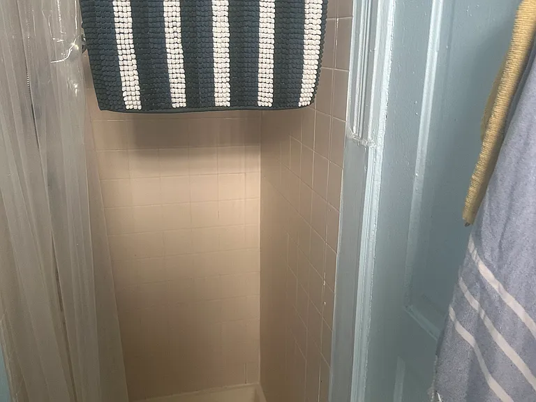 The bathroom here does not have a bathtub, only a shower