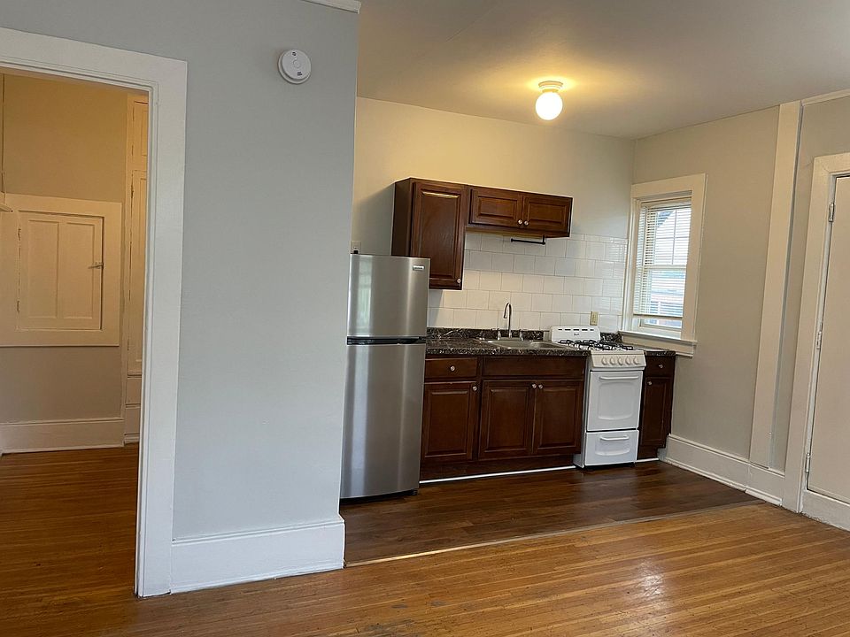 Kitchen with brand new fridge and stove; opens to living/sleeping area