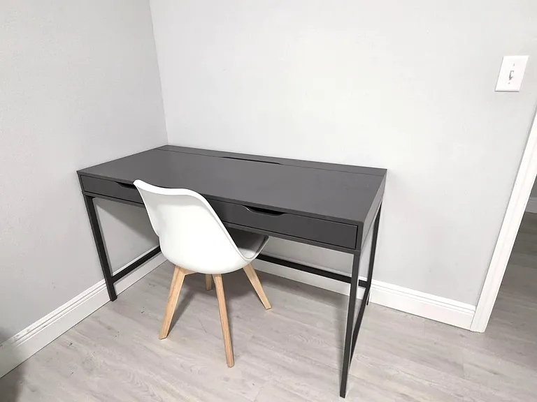 Compact work nook with a dedicated desk and chair, ideal for remote work or study with easy access to nearby rooms.