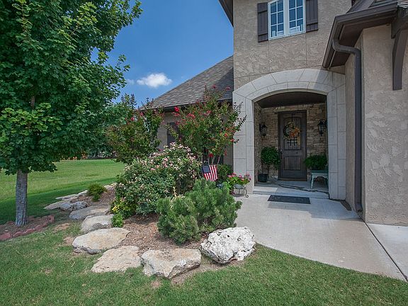 Large, stately covered front porch and professional landscaping