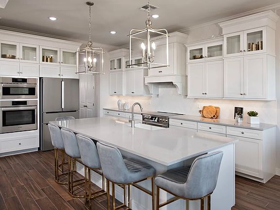 Kitchen with pendant lighting and glass upper cabinets