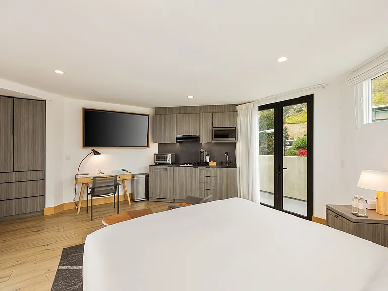 Enjoy your downtime with a sleek flat-screen TV, perfect for unwinding after a day of beach activities.