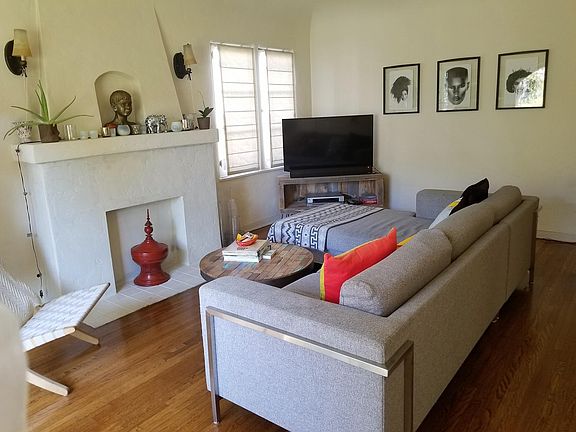 livingroom with fireplace mantle and hardwood floors
